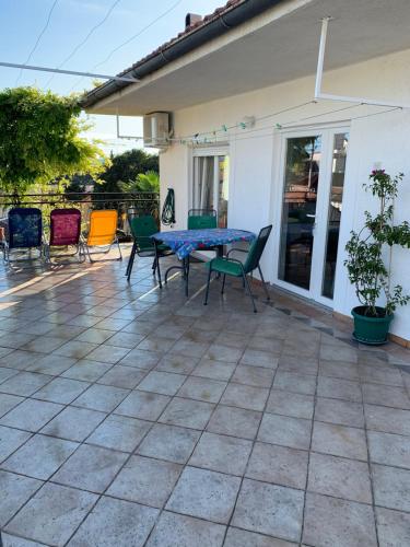 a patio with a table and chairs on a house at Apartment Lucija in Novi Vinodolski