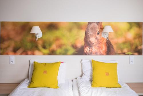 a picture of a squirrel sitting on top of a bed at Cicha Zdrój in Solec-Zdrój