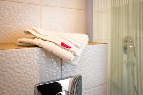a towel on a shelf in a bathroom with a mirror at Cicha Zdrój in Solec-Zdrój