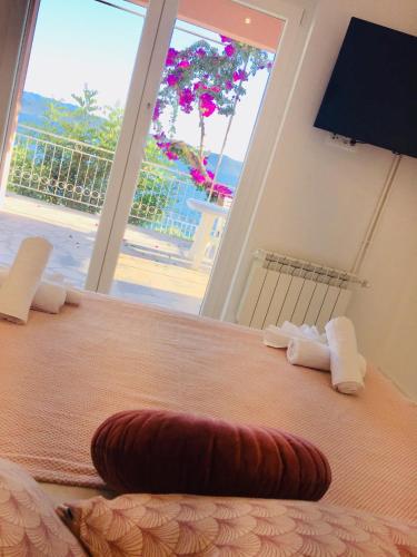 a bedroom with a bed with a view of the beach at Apartments Juraković in Živogošće