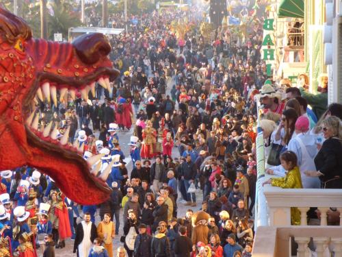 a large crowd of people walking down a street at Villa Tina Hotel in Viareggio