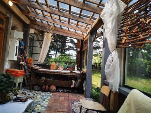 patio z drewnianą pergolą i stołem w obiekcie Gold Sun Zelta Saule w mieście Matkule
