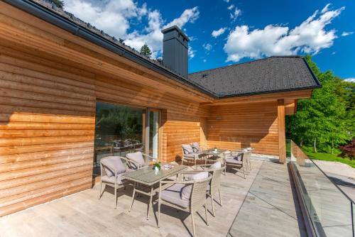 a patio with a table and chairs on a deck at Vila Alpina in Bled