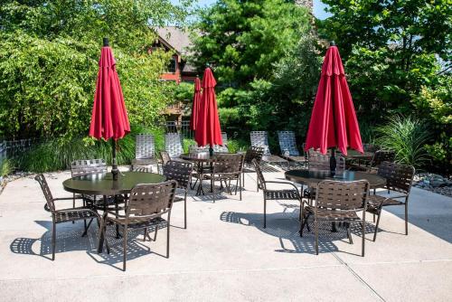 a group of tables and chairs with red umbrellas at Hawk Hill in Vernon Township
