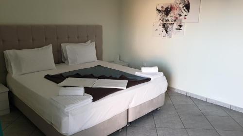 a bed with white sheets and pillows in a room at Vista Marina in Kalamata