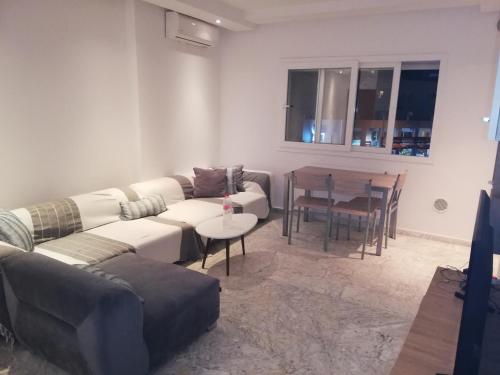 a living room with a couch and a table at Costa Marina 212 in Hammamet