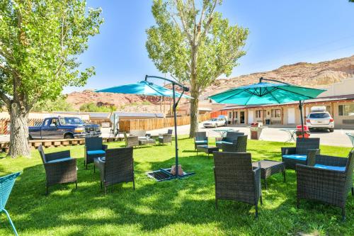 a group of chairs and tables in the grass at Adventure Inn Moab in Moab