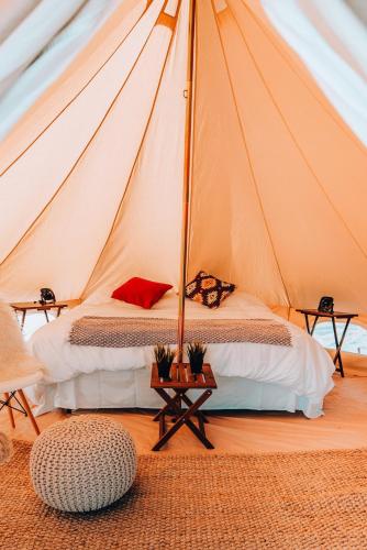 a bedroom with a bed in a tent at Wander Camp Yellowstone in Island Park