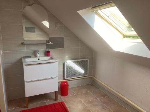 a bathroom with a sink and a skylight at Moulin des Baleines de Kérandraon Plouguerneau in Plouguerneau