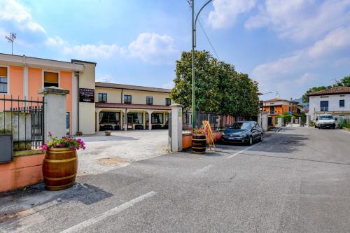 a parking lot with a car parked in front of a building at Albergo Locanda Primavera in Rodengo Saiano