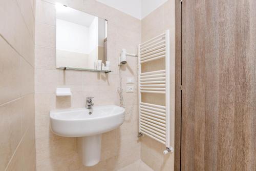 a bathroom with a white sink and a mirror at Albergo Locanda Primavera in Rodengo Saiano