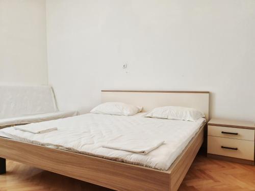a bedroom with a large bed with white sheets at BetaNovalja in Novalja