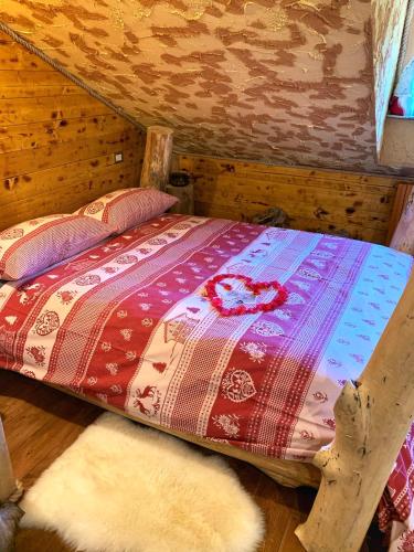 a bed in a room with two rugs at ALLA STALLA Suite & Chalet in Piazzatorre