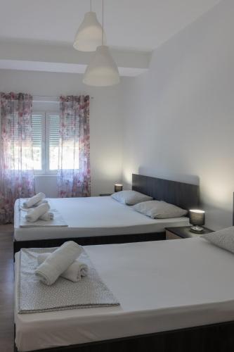 two beds in a bedroom with towels on them at Apartments IVI Gevgelija in Gevgelija