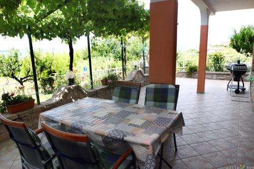 een tafel en stoelen op een terras bij Apartmaji ORKO s pogledom na morje - Sea View Apartments ORKO in Portorož