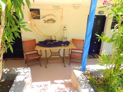a patio with a table and two chairs at Kalamitsi Studios in Kalamitsi