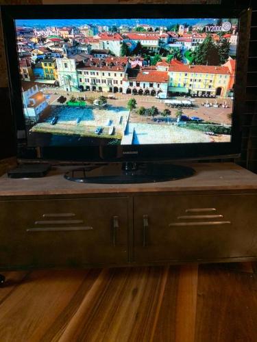a flat screen tv sitting on top of a table at Il Giardino Segreto Arona, Charming Apartments in Arona