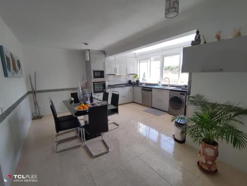 a large kitchen with a table and chairs in it at Vivenda Diniz in Silves