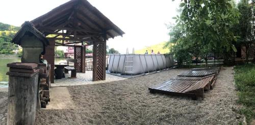 two benches sitting next to a pavilion in a park at Casa Paty Orsova in Orşova