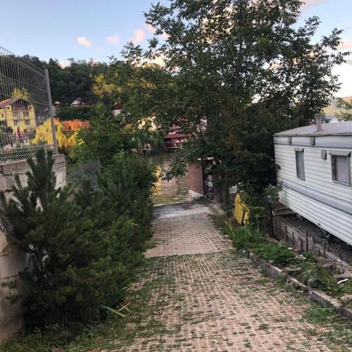 a brick road next to a house and a canal at Casa Paty Orsova in Orşova