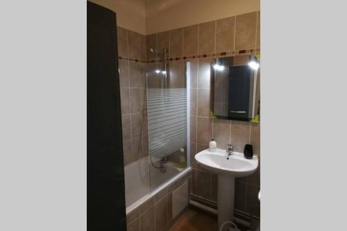 une salle de bain avec un lavabo et des toilettes et une baignoire et un lavabo dans l'établissement Les écuries du chateau, à Commes