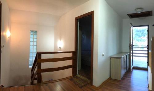 an empty room with a stairway and a door at Casa Rares in Orşova
