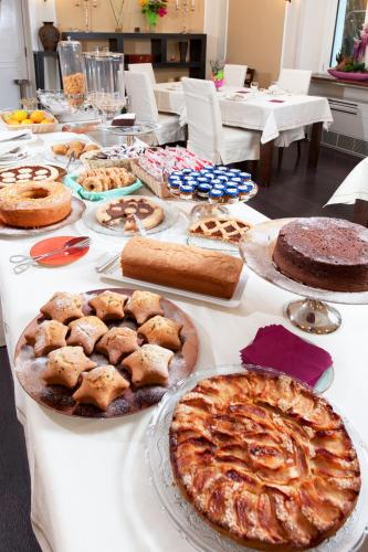 a long table with pies and pastries on it at Villa Maria Cristina in Caserta