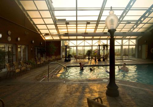 a pool in a building with people in the water at Carlisle Inn in Sugarcreek