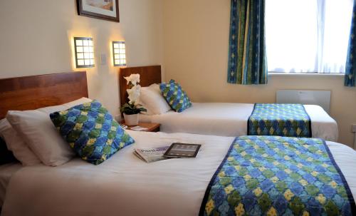 a hotel room with two beds and a book at Heights Hotel in Portland