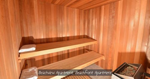 a wooden sauna with a wooden shelf in it at Bay Of Islands Beachhouses in Paihia