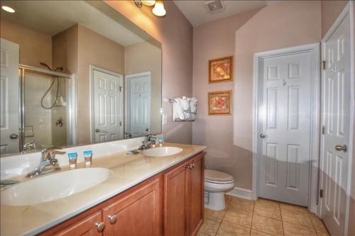 a bathroom with two sinks and a toilet at 612 Egret Run Cabin in North Myrtle Beach