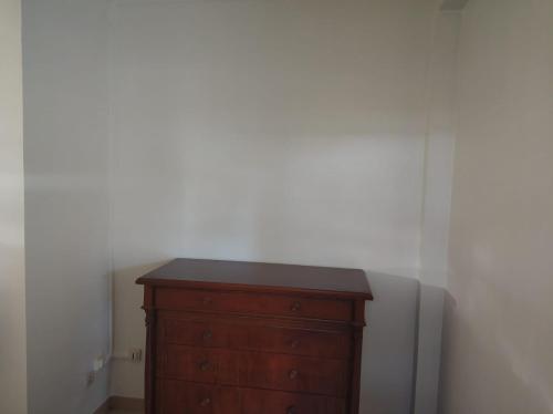 a wooden dresser in a room with a white wall at Mandariniers 97232-2 in Le Lamentin