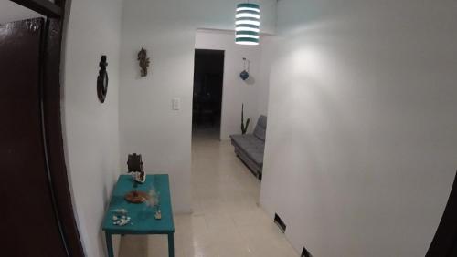 a hallway with a blue table and a couch at Marmows Place in San Andrés