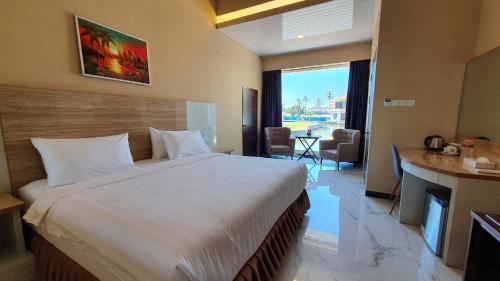 a bedroom with a large bed and a living room at Cahaya Villa Garut in Garut