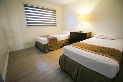 A bed or beds in a room at Oceanview Hotel and Residences