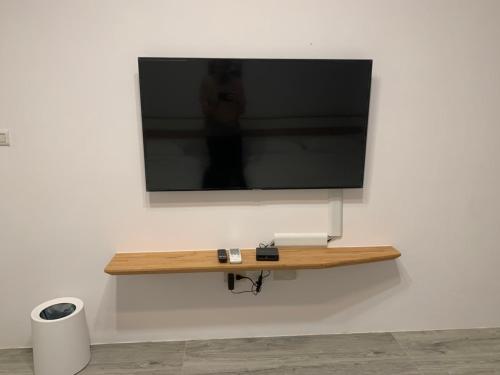 a flat screen tv hanging on a wall at Lanshan Guest House in Taitung City