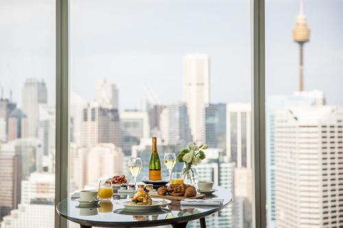 
a table topped with plates of food and drinks at Sofitel Sydney Darling Harbour in Sydney
