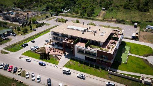 an aerial view of a large building with cars parked in a parking lot at Allure Healthy Hotel & Spa in Eger
