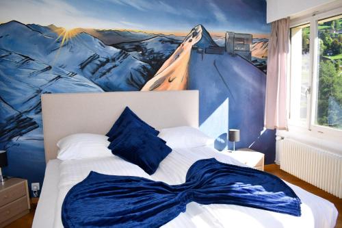 a bedroom with a bed with a painting on the wall at Hostellerie d'Orzival in Vercorin