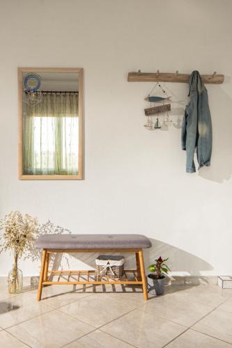 a bench sitting in a room with a wall at Villa Ble in Nea Vrasna