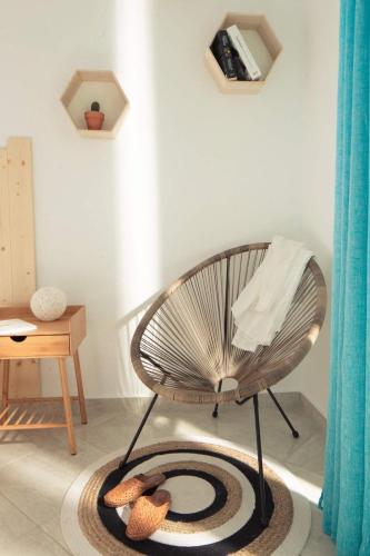 a chair sitting on a rug in a room at Villa Ble in Nea Vrasna