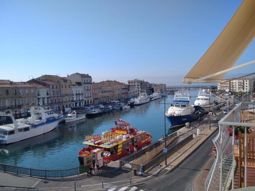 a group of boats are docked in a harbor at Grand T2 au COEUR DE VILLE avec VUE SUR QUAIS ET MER in Sète