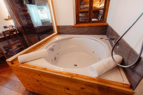 a bath tub in a bathroom with a shower at Maison Bionaz Ski & Sport in Aosta