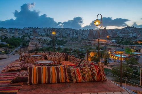 a group of couches on a balcony with a view at Hera Cave Suites in Goreme