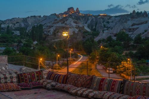 a group of pillows sitting on a balcony with a mountain at Hera Cave Suites in Goreme