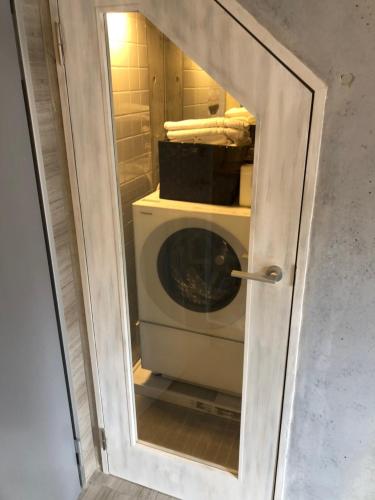 a door to a washing machine in a room at Luxury Condo Shikine An Gion Shirakawa in Kyoto