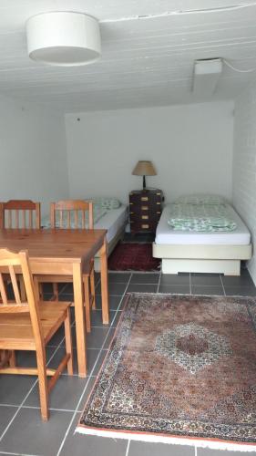 a dining room with a table and a bed at Bel Air in Norderstedt