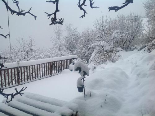 a yard covered in snow with a fence at Haus Altenberger by we rent, SUMMERCARD INCLUDED in Zell am See