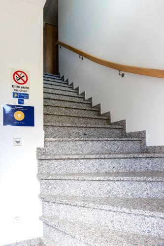 a set of stairs in a building with a no smoking sign at Pension am See in Kremmen