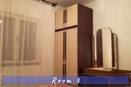 a room with a refrigerator and a curtain at Near the sea vacation home Parja in Vis